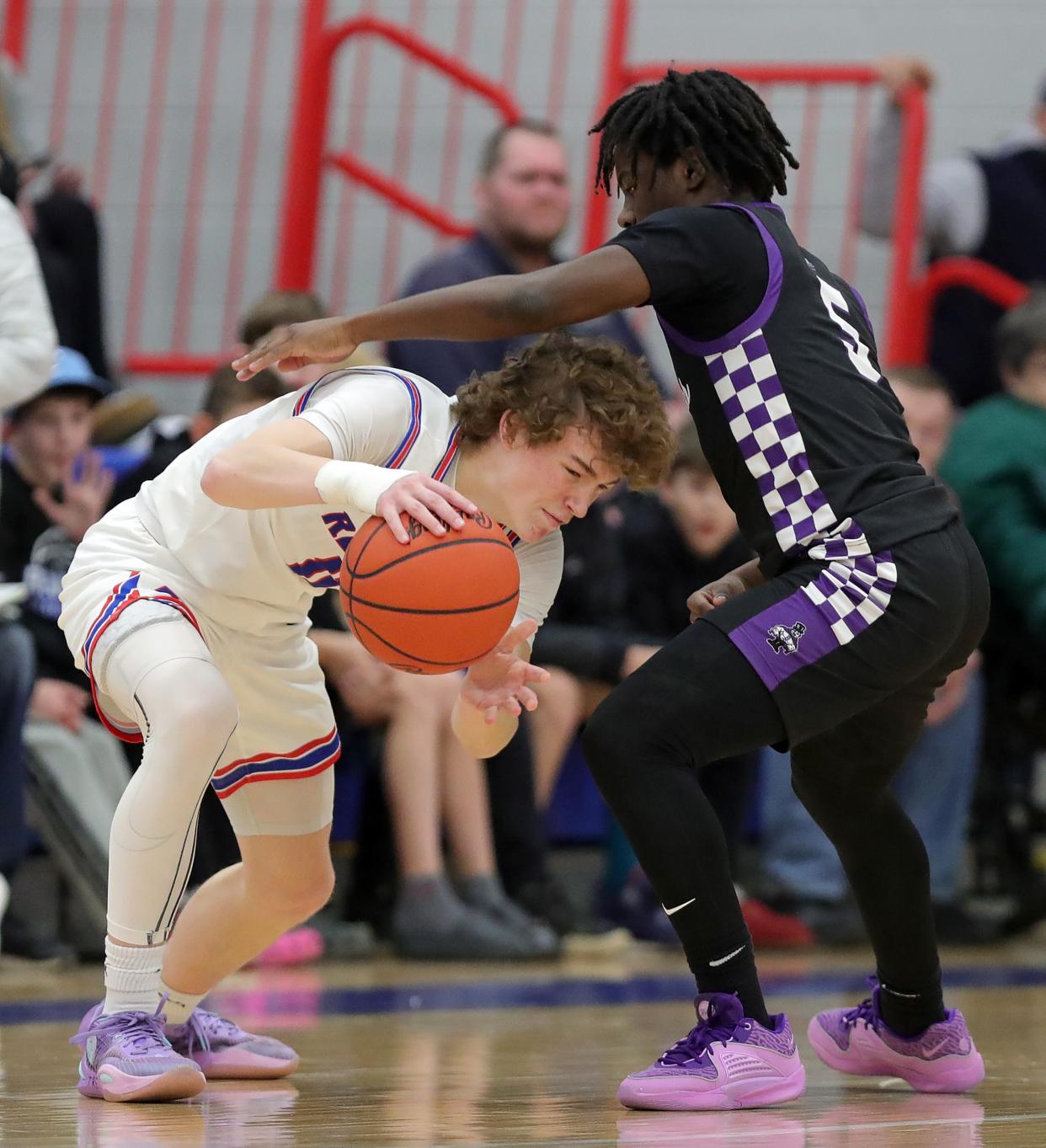 Revere's Conner Groce, left, gets around Barberton guard Kardiay Tyler, Tuesday, Feb. 13, 2024.