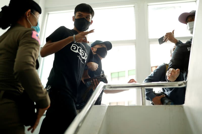 Panupong Jadnok, a pro-democracy student, one of the leaders of Thailand's recent anti-government protests, is escorted after being arrested, at the police station in Bangkok