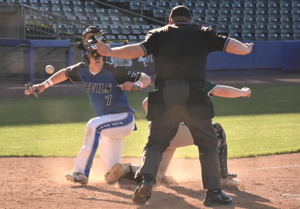 Camden's Trey O'Rourke (left) makes a safe sign and checks to see the same from the umpire as the ball gets by him at home plate during Thursday's Strike Out Lou Gehrig's Disease game against Westmoreland at NBT Bank Stadium in Syracuse.