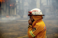 A firefighter covers his face while battling the Morton Fire near Bundanoon, New South Wales, Australia, on Thursday, Jan. 23, 2020. (AP Photo (AP Photo/Noah Berger)