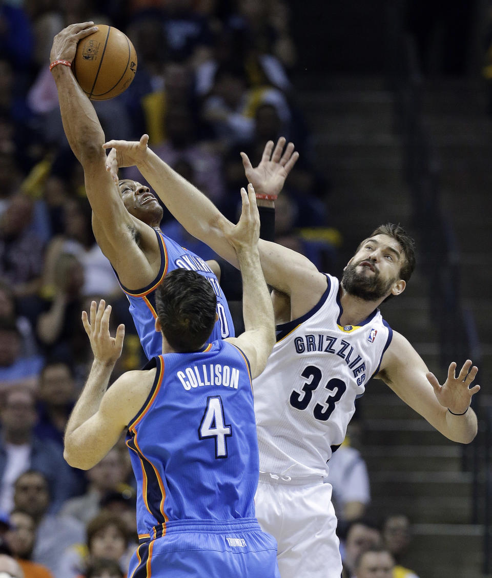 Memphis Grizzlies center Marc Gasol (33) reaches for a rebound with Oklahoma City Thunder's Russell Westbrook, top, and Nick Collison (4) during the first half of Game 4 of an opening-round NBA basketball playoff series Saturday, April 26, 2014, in Memphis, Tenn. (AP Photo/Mark Humphrey)