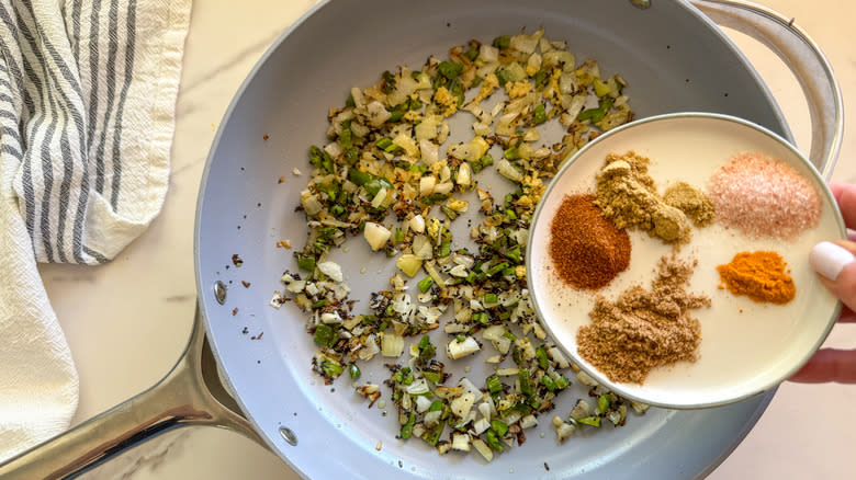 hand adding spices