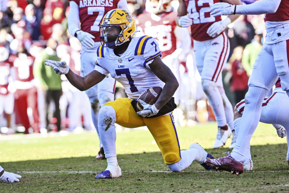 FILE - LSU wide receiver Kayshon Boutte (7) reacts after making a first down against Arkansas during an NCAA college football game Saturday, Nov. 12, 2022, in Fayetteville, Ark. College football administrators are looking at ways to reduce the number of plays in games in the name of player safety, with a tweak in clock operating procedures likely the first step. A proposal to let the game clock continue running when a team makes a first down, except in the last two minutes of a half, has broad support. (AP Photo/Michael Woods, File)