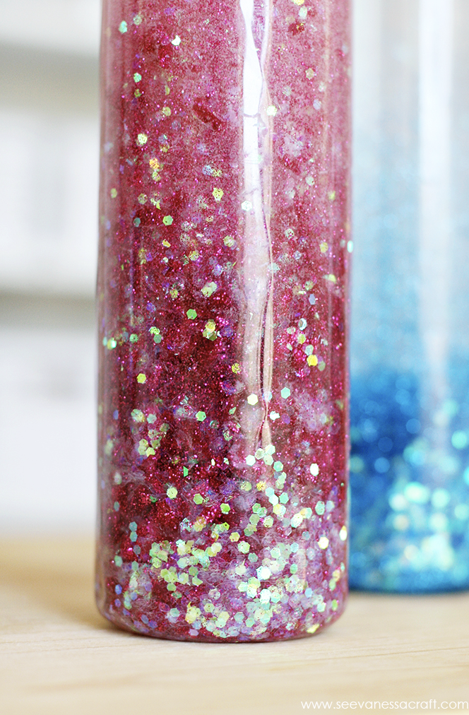 crafts for kids glitter sensory bottle filled with water and red glitter