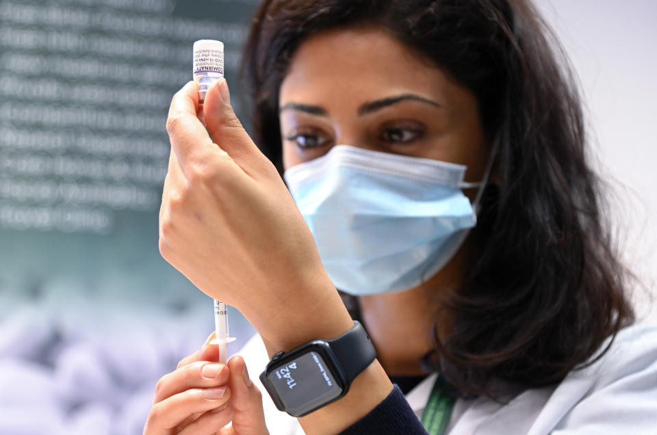 BOREHAMWOOD, ENGLAND - OCTOBER 04: A pharmacist prepares to give a COVID-19 booster vaccination at the MedMart pharmacy on October 04, 2021 in Borehamwood, England. Frontline health and care workers in England are being offered a booster COVID-19 vaccination ahead of the winter months. (Photo by Karwai Tang/Getty Images)