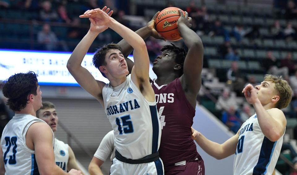 Lyons’ Jamire Johnson, second from right, looks to put back a rebound against Moravia's Kyler Proper, left, Abram Wasileski and Aiden Kelly during a NYSPHSAA Class C Boys Basketball Championships semifinal in Glens Falls, N.Y., Friday, March 15, 2024. Lyons’ season ended with a 56-45 loss to Moravia-IV.