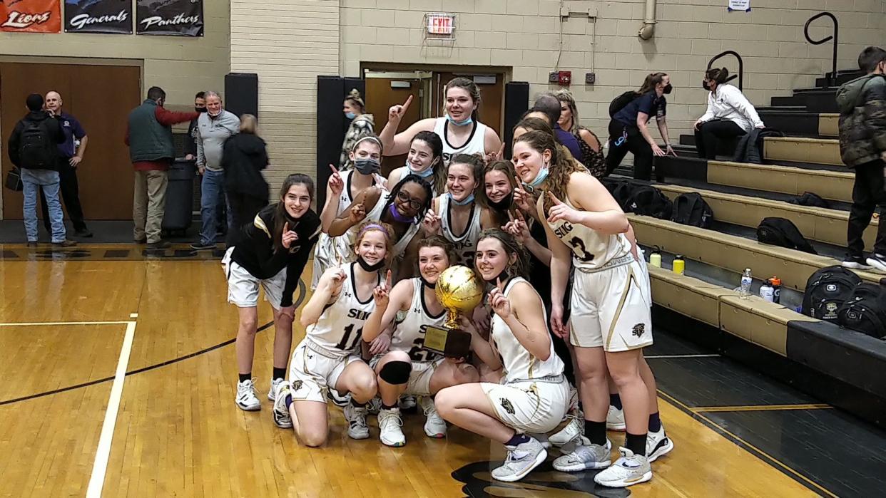 The Sacred Heart-Griffin girls basketball team celebrates its win in the 2021-22 City Tournament in Springfield.