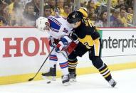 New York Rangers center J.T. Miller (10) and Pittsburgh Penguins defenseman Olli Maatta (3) battle for the puck during the third period in game two of the first round of the 2016 Stanley Cup Playoffs at the CONSOL Energy Center. The Rangers won 4-2. Mandatory Credit: Charles LeClaire-USA TODAY Sports