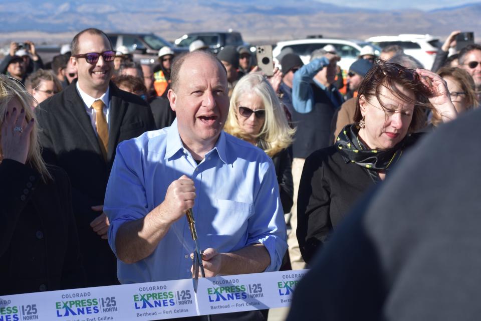 Gov. Jared Polis cuts the ceremonial ribbon celebrating the substantial opening of the North I-25 Express Lanes project at a ceremony at the I-25 bus slip in Loveland on Dec. 7, 2023. The new express lanes and two general purpose lanes will open Dec. 15, 2023.