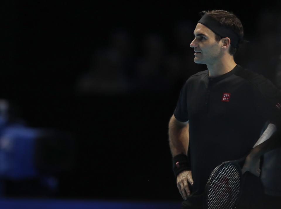 Switzerland's Roger Federer talks to the umpire as he plays against Austria's Dominic Thiem during their ATP World Tour Finals singles tennis match at the O2 Arena in London, Sunday, Nov. 10, 2019. (AP Photo/Alastair Grant)