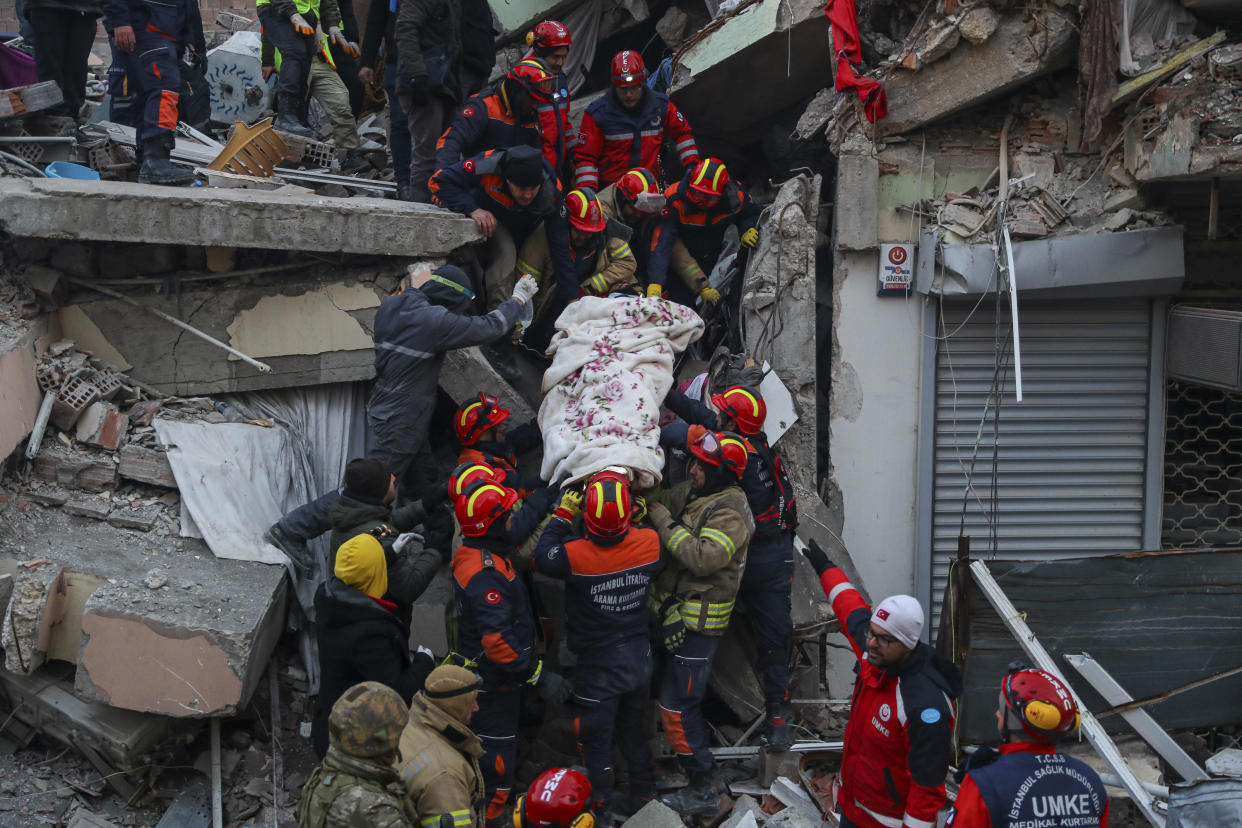 Turkish rescue workers carry Ergin Guzeloglan, 36, to an ambulance after pulled him out from a collapsed building five days after an earthquake in Hatay, southern Turkey, early Saturday, Feb. 11, 2023. Emergency crews made a series of dramatic rescues in Turkey on Friday, pulling several people, some almost unscathed, from the rubble, four days after a catastrophic earthquake. (AP Photo/Can Ozer)