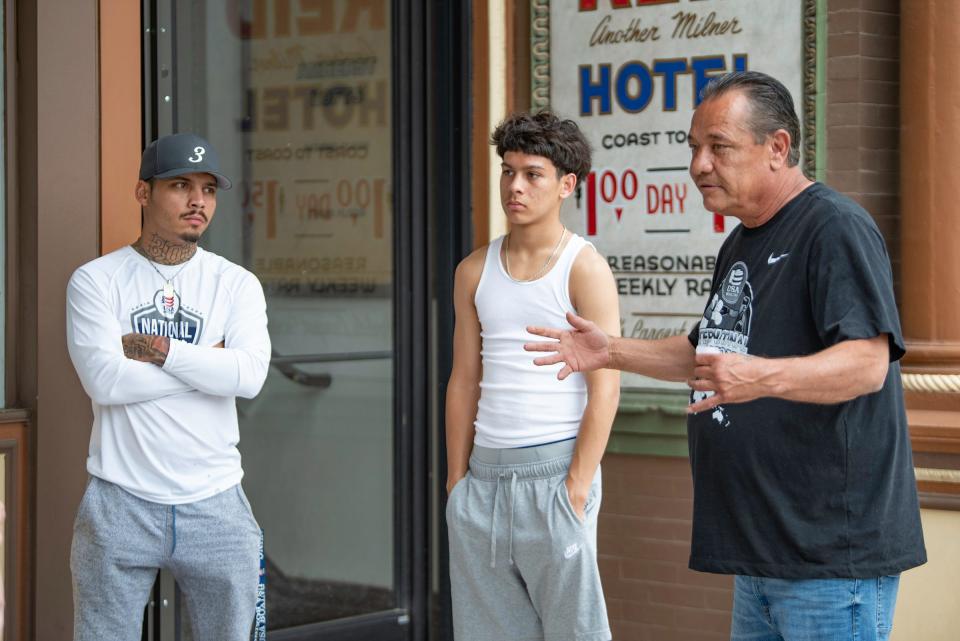 Carlos Fernandez, left, and Micael Fernandez listen as Scott Gomez, right, speaks about his experience working with Ybarra's Boxing Club on Thursday.