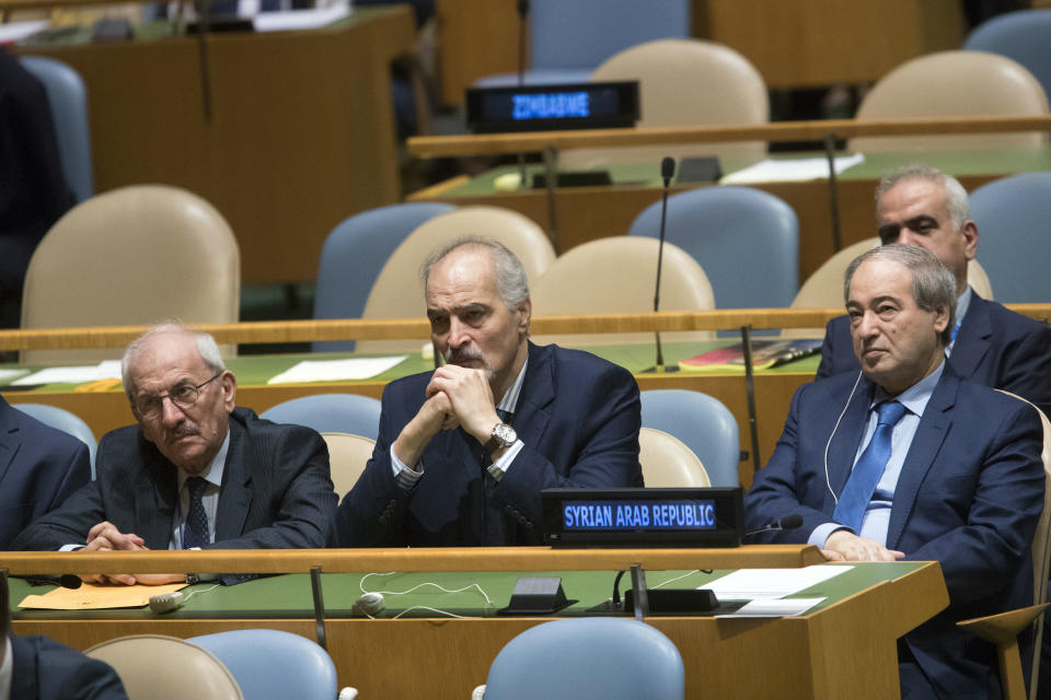 CORRECTS NAME OF SYRIAN DEPUTY PRIME MINISTER TO WALID AL-MOALLEM - Syrian Ambassador to the United Nations Bashar Ja'afari, center, and other members of the Syrian delegation listen as Deputy Prime Minister Walid al-Moallem addresses the 73rd session of the United Nations General Assembly,Saturday, Sept. 29, 2018 at U.N. headquarters. (AP Photo/Mary Altaffer)