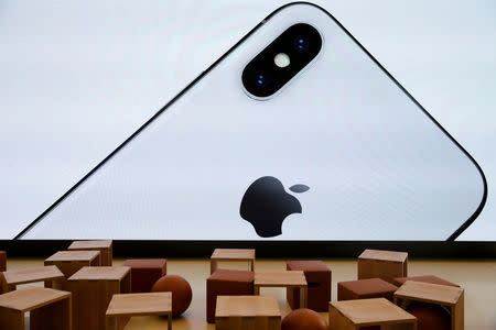 FILE PHOTO: An iPhone X is seen on a large video screen in the new Apple Visitor Center in Cupertino, California, U.S., November 17, 2017. REUTERS/Elijah Nouvelage/File Photo