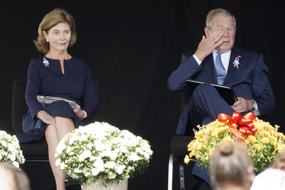 Former President George W. Bush, right, wipes his eyes next to former first lady Laura Bush, after he spoke at a memorial for the passengers and crew of United Flight 93, Saturday, Sept. 11, 2021, in Shanksville, Pa., on the 20th anniversary of the Sept. 11, 2001, attacks. (AP Photo/Jacquelyn Martin)