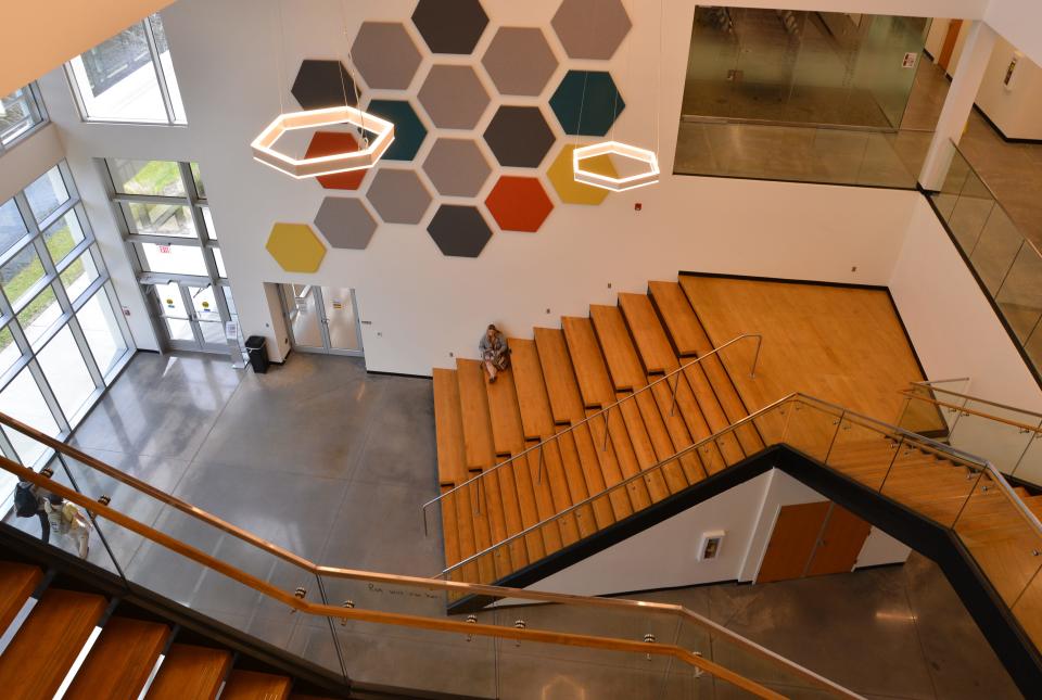 A student sits between classes in the lobby of the new Gordon L. Nelson Health Services building, which opened last August.