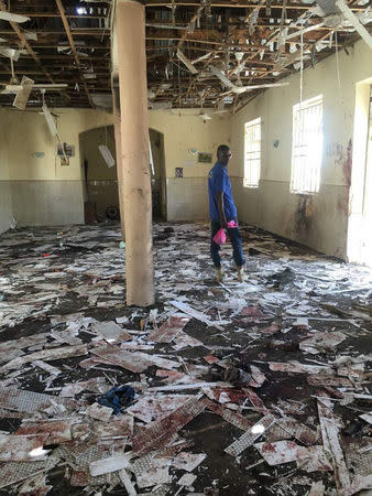 A man inspects the damage inside a mosque at the site of a suicide bomber attack in Mubi in Adamawa state, in northeastern Nigeria November 21, 2017. NEMA/Handout via REUTERS