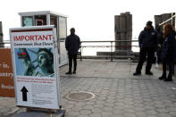 A sign announcing the closure of the Statue of Liberty, due to the U.S. government shutdown, sits near the ferry dock to the Statue of Liberty at Battery Park in Manhattan, New York, U.S. January 21, 2018. REUTERS/Shannon Stapleton