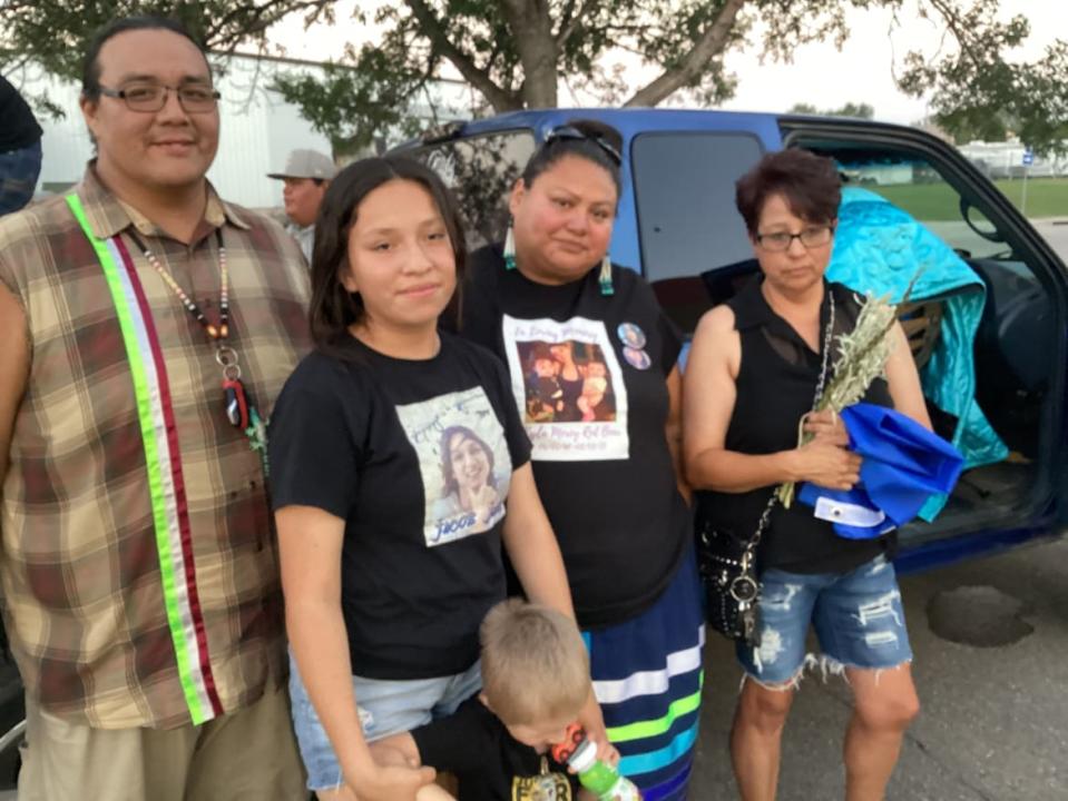 Jen Red Bear, right, and other family members accepted hugs and expressions of sympathy from the scores of people who attended the vigil outside of Brookings, S.D., Monday night.