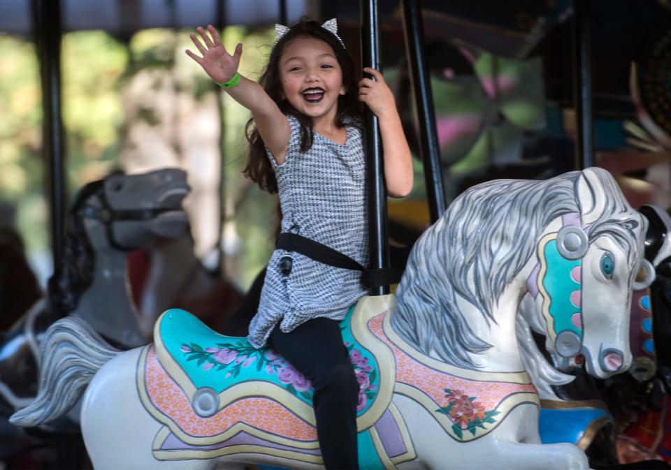 S20181020 

Wearing cat ears, 5-year-old Ariel Mejia rides the carousel at the Monster Mash Halloween Bash at Pixie Woods in Stockton. Children wearing a costume got in free for the day.