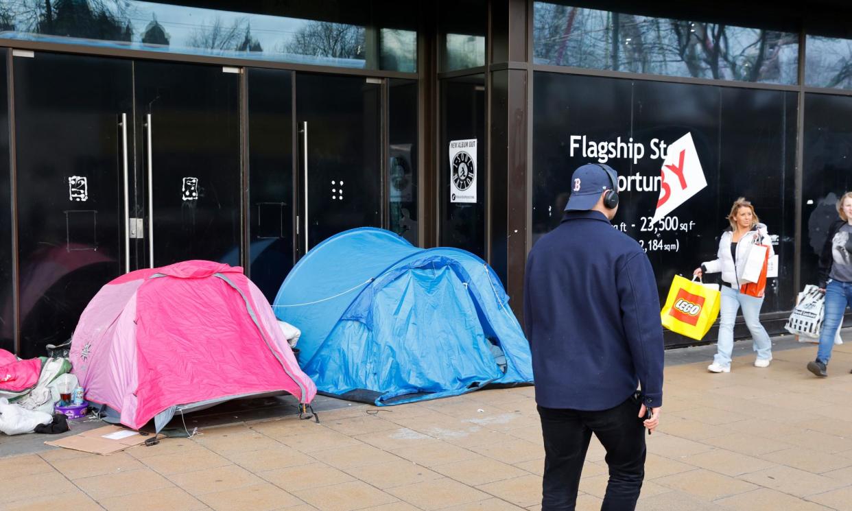 <span>Shoppers on Princes Street in Edinburgh walk past tents and sleeping bags erected by homeless people.</span><span>Photograph: Murdo MacLeod/The Guardian</span>