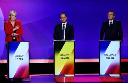 From L-R, French presidential candidates, Marine Le Pen, French National Front (FN) political party leader, Benoit Hamon, of the Socialist Party, and Francois Fillon, member of the Republicans political party candidate of the French centre-right (R) attend the France 2 television special prime time political show, "15min to Convince" in Saint-Cloud, near Paris, France, April 20, 2017. REUTERS/Martin Bureau/Pool