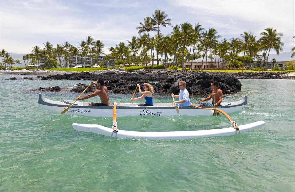 This photo provided by Fairmont Orchid shows a couple canoeing at the resort along the Kohala Coast, Hawaii. Some resorts that cater to honeymooners offer registries and at the Fairmont Orchid couples can request that friends and relatives chip in toward spa treatments, romantic dinners and sunrise canoe outings. (Fairmont Orchid via AP)