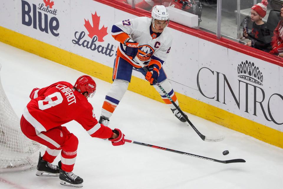 Detroit Red Wings defenseman Ben Chiarot defends New York Islanders left wing Anders Lee during the first period at Little Caesars Arena in Detroit on Thursday, Feb. 29, 2024.