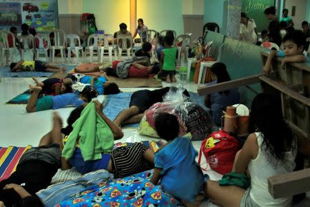 Residents celebrating Christmas Day at the evacuation center take a break before Typhoon Nock-ten is expected to strike Legazpi City, Albay province, central Philippines December 25, 2016. REUTERS/Stringer