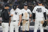 New York Yankees manager Aaron Boone, left, removes pitcher Carlos Rodon, second from left, from the game in the seventh inning of a baseball game against the Miami Marlins, Tuesday, April 9, 2024, in New York. (AP Photo/Mary Altaffer)