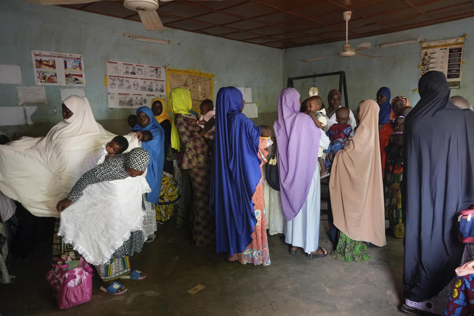 Women gather at a clinic to have their children vaccinated in Niamey, Niger, Monday, , Aug. 21, 2023. Severe economic and travel sanctions imposed by the West African regional bloc ECOWAS after mutinous soldiers ousted the country's democratically elected president in July, are taking a toll on Nigeriens and causing concern for health workers. (AP Photo/Sam Mednick)