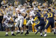 Collin Klein #7 of the Kansas State Wildcats drops back to pass against the West Virginia Mountaineers during the game on October 20, 2012 at Mountaineer Field in Morgantown, West Virginia. (Photo by Justin K. Aller/Getty Images)