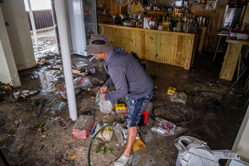 <p>A man removes damaged food from a restaurant affected during the passing of Hurricane Fiona in Penuelas, Puerto Rico September 19, 2022. REUTERS/Ricardo Arduengo</p> 