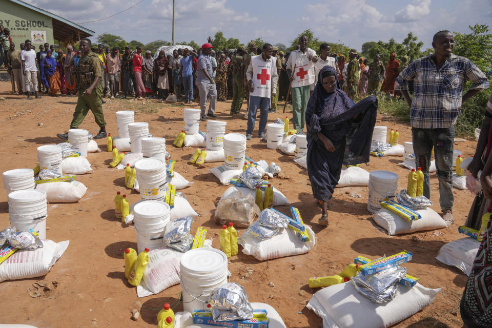 Residents gather for a planned distribution of food, after El Niño rains damaged their houses, in Mandera County, Kenya, Wednesday, Dec. 13, 2023. (AP Photo/Brian Inganga)