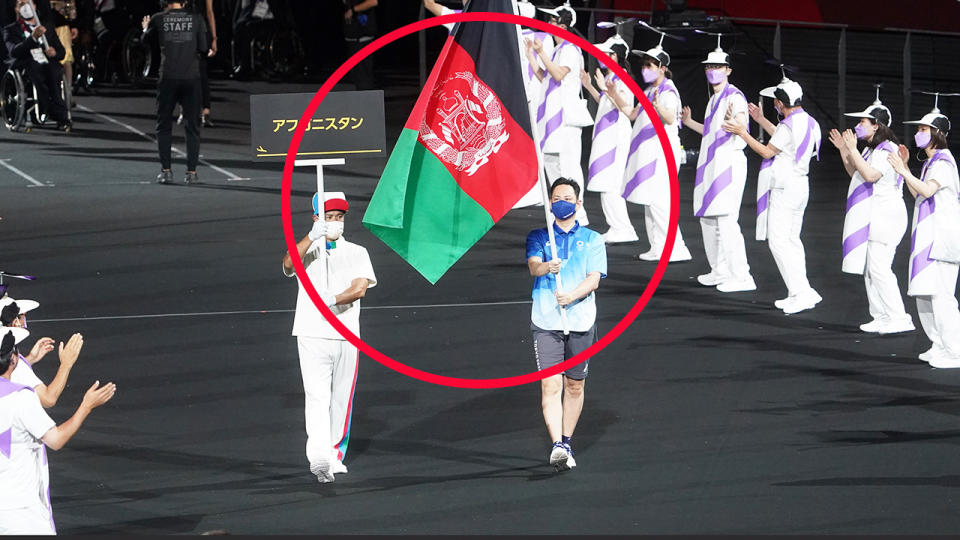 The flag of Afghanistan, pictured here being carried by volunteers at the Paralympics opening ceremony.