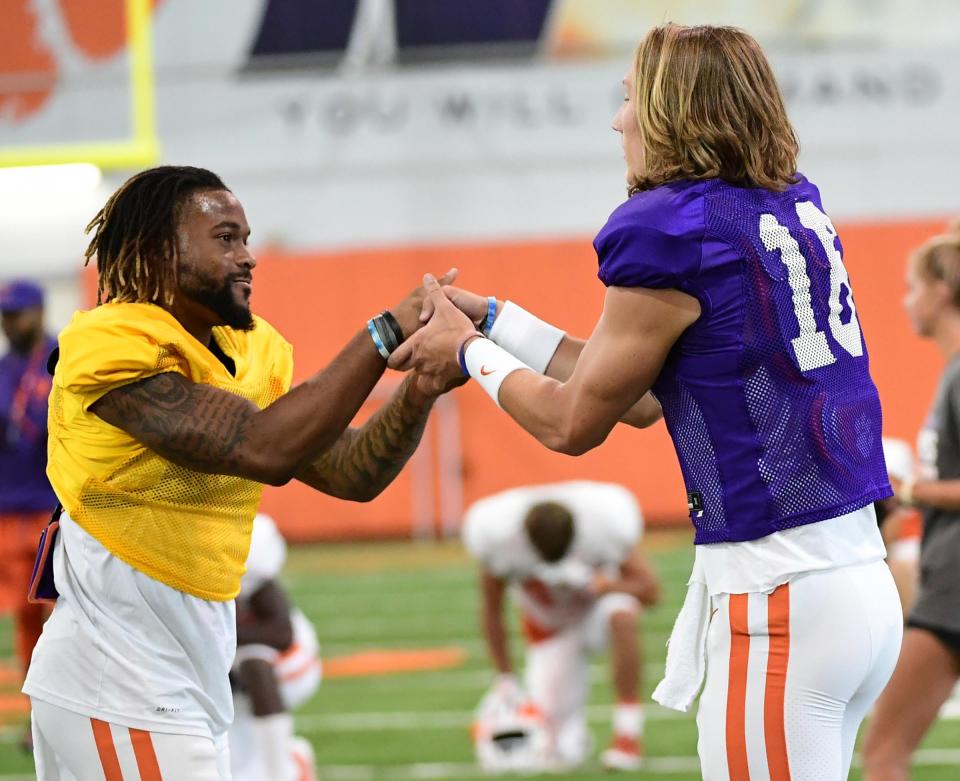 Clemson wide receiver Amari Rodgers (3) greets quarterback Trevor Lawrence (16) during practice at the Poe Indoor Facility at Clemson Tuesday, August 20, 2019.