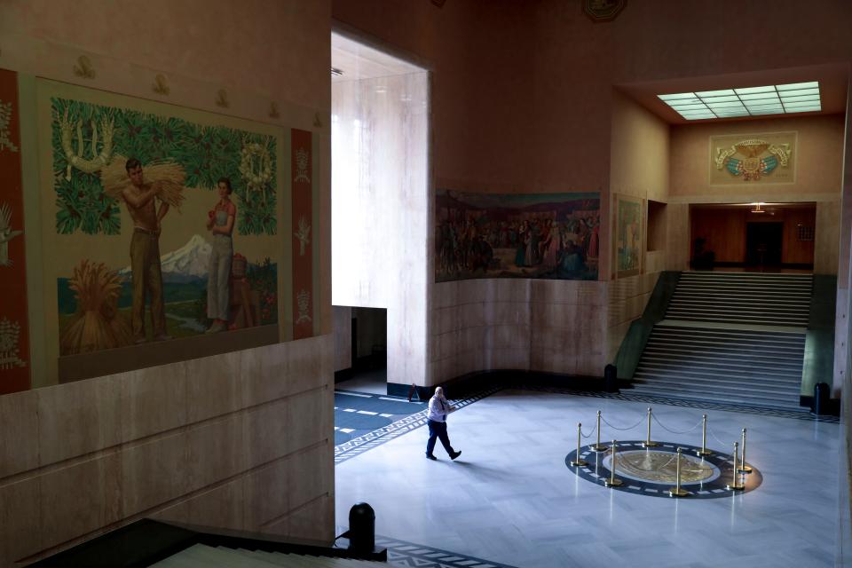 A member of the Oregon State Capitol staff walks through the rotunda on June 24, 2020. The central section of the building, including the rotunda, is closed for renovations until January 2025.