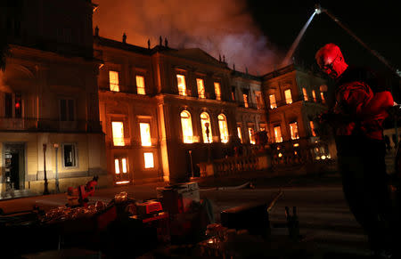 People rescue items during a fire at the National Museum of Brazil in Rio de Janeiro, Brazil September 2, 2018. REUTERS/Ricardo Moraes