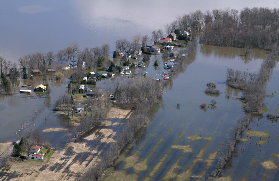 A flooded neighborhood is seen in Rigaud, Quebec, Canada on Tuesday, April 30, 2019.  Thousands of people have been forced from their homes in Quebec, Ontario and New Brunswick.  (Paul Chiasson/The Canadian Press via AP)