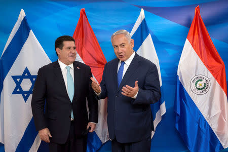 Israeli Prime Minister Benjamin Netanyahu gestures as he stands next to Paraguayan President Horacio Cartes during a meeting at the Prime Minister's office in Jerusalem, following the dedication ceremony of the embassy of Paraguay in Jerusalem, May 21, 2018. Sebastian Scheiner/Pool via Reuters