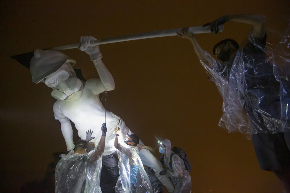 Anti-government protesters setup a 4-meter tall statue "The Lady Liberty of Hong Kong", that symbolizes the city's recent democratic movement, was brought to Lion Rock, one of Hong Kong's iconic peaks Sunday morning in Hong Kong, Sunday, Oct. 13, 2019. (AP Photo/Kin Cheung)