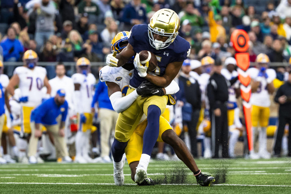 Notre Dame wide receiver Tobias Merriweather (5) makes a catch as Pittsburgh defensive back M.J. Devonshire, back, defends him during the second half of an NCAA college football game Saturday, Oct. 28, 2023, in South Bend, Ind. (AP Photo/Michael Caterina)