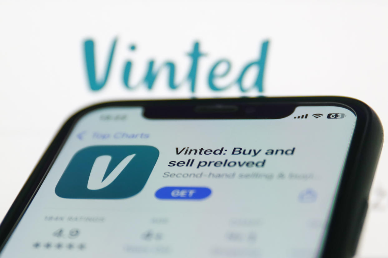 search Vinted on App Store displayed on a phone screen and Vinted website displayed on a screen in the background are seen in this illustration photo taken in Krakow, Poland on January 19, 2023. (Photo by Jakub Porzycki/NurPhoto via Getty Images)