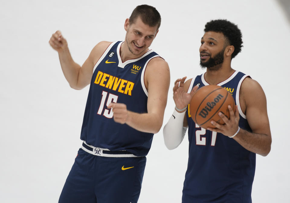 FILE - Denver Nuggets center Nikola Jokic, left, jokes around with guard Jamal Murray during the NBA basketball team's Media Day, Monday, Sept. 26, 2022, in Denver. The team opens the season at Utah on Oct. 19. (AP Photo/David Zalubowski, File)