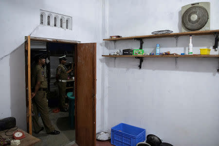 Police officers stand outside a room in a watchtower at a training camp allegedly linked to Islamist militants, in Kattankudy near Batticaloa, Sri Lanka, May 5, 2019. REUTERS/Danish Siddiqui