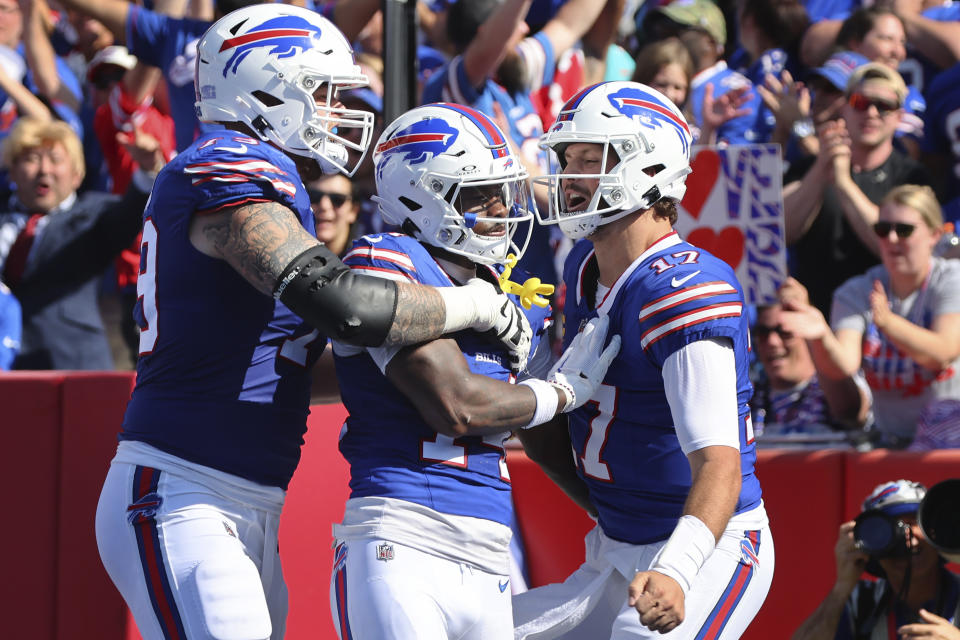 Stefon Diggs, center, celebrates a touchdown with Josh Allen, right and  Spencer Brown. (AP Photo/Jeffrey T. Barnes)