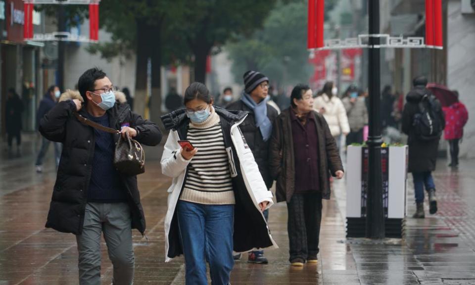 Masked pedestrians in downtown Wuhan, China, the city where the outbreak originated.