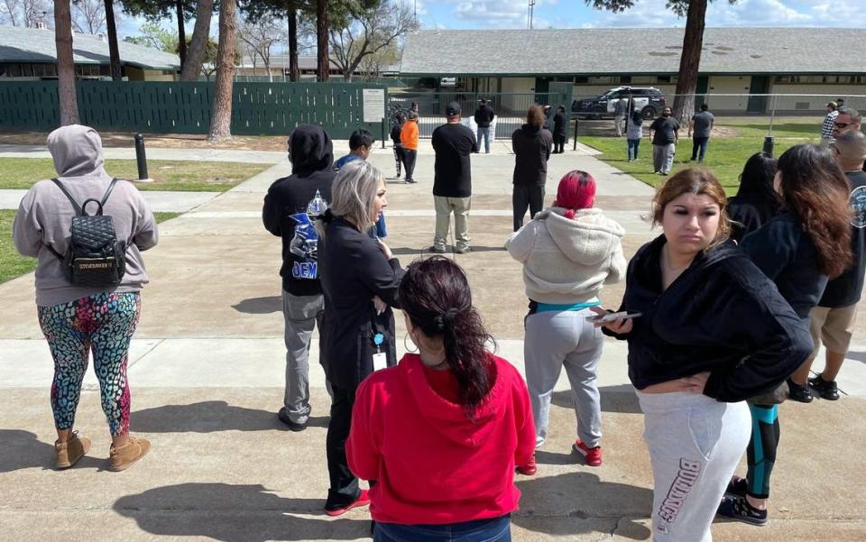 Concerned parents gather outside Herbert Hoover High School after a hoax call from outside the area forced a lockdown Friday around noon, March 24, 2023 in Fresno.