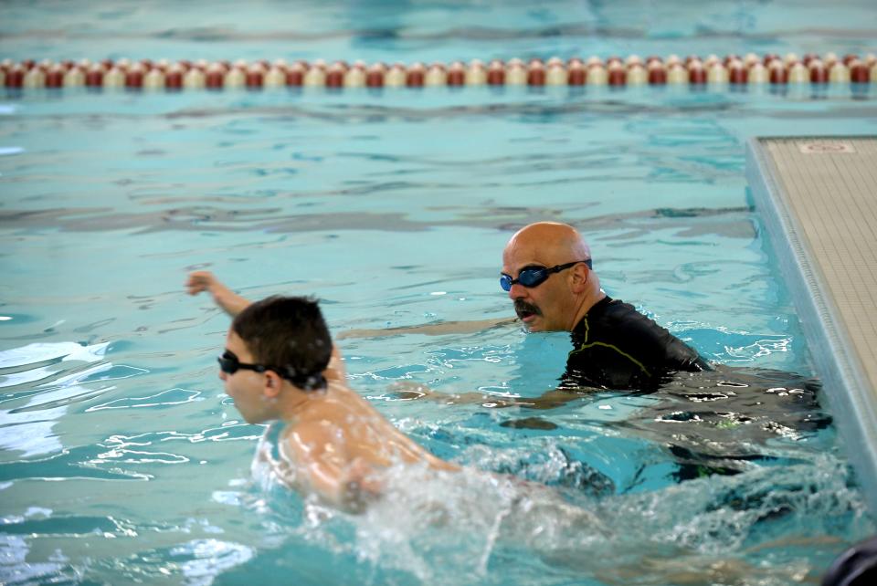 Plain Local school resource officer Deputy Steve Shaffer takes to the water to support first grade students from Frazer Elementary School as they take swim lessons at the Eric Snow Family YMCA in Canton as part of a partnership between the YMCA and Plain Local Schools.