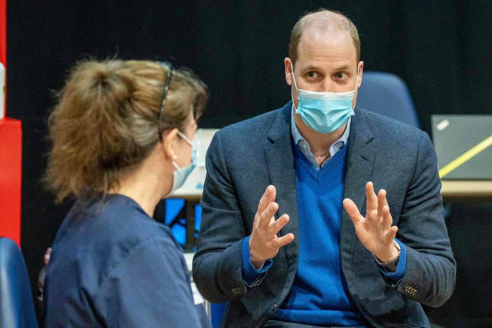 <p>Prince William talks with staff at a coronavirus vaccination center at Kings Lynn Corn Exchange on Monday in Kings Lynn, England. </p>